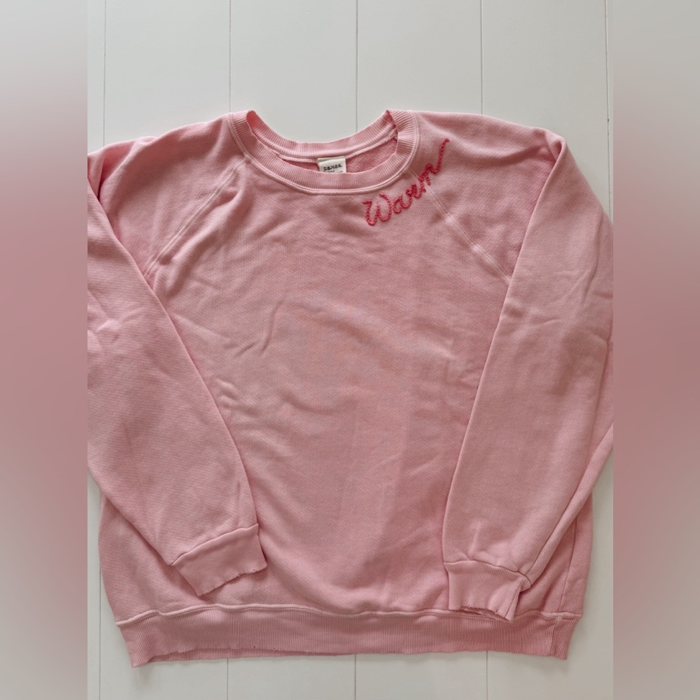 pink crewneck with warm written on it!